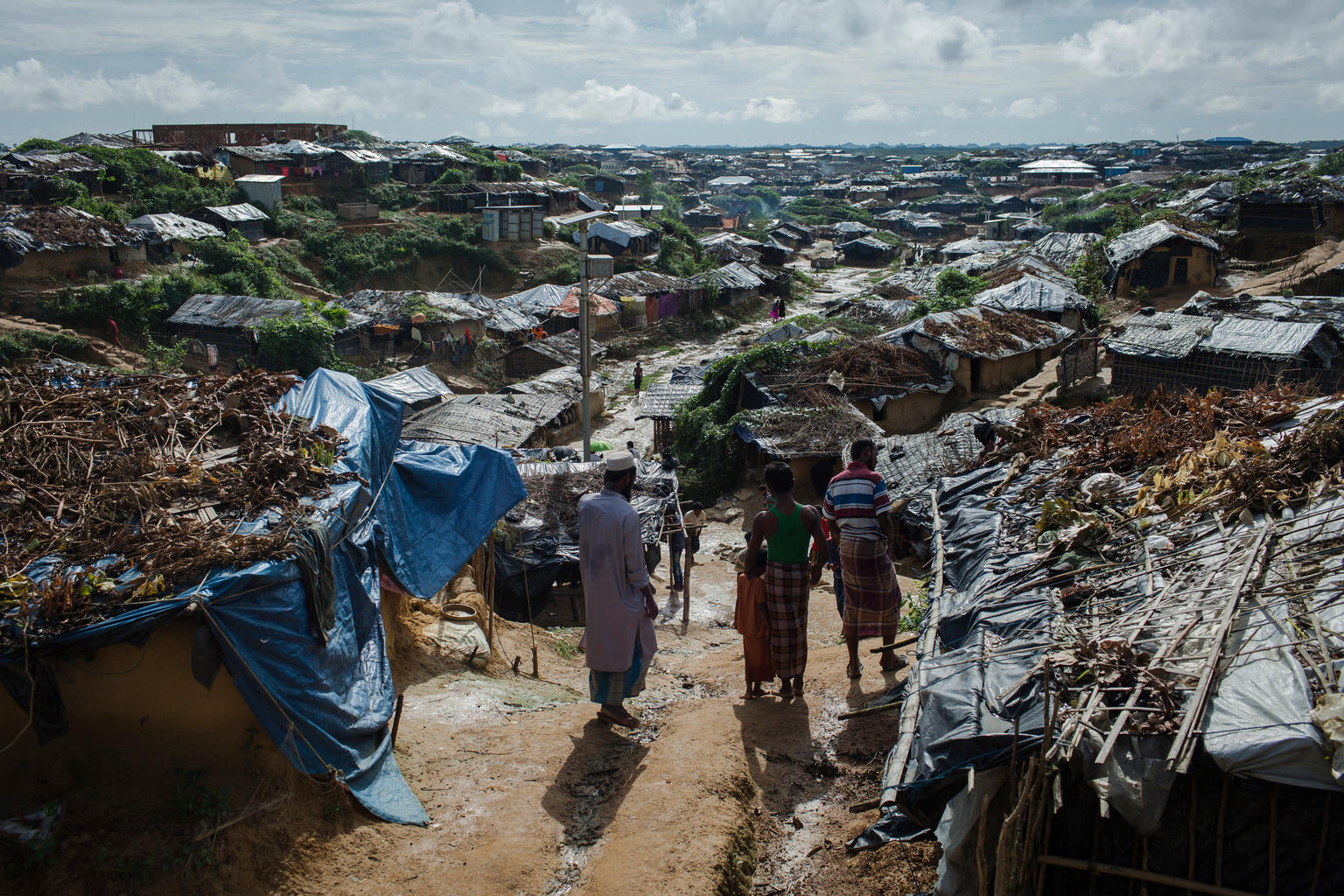 On 8 September 2017 in Bangladesh, Rohingya refugees stand on a hill overlooking dwellings in the Kutupalong makeshift refugee camp, in Cox’s Bazar district.