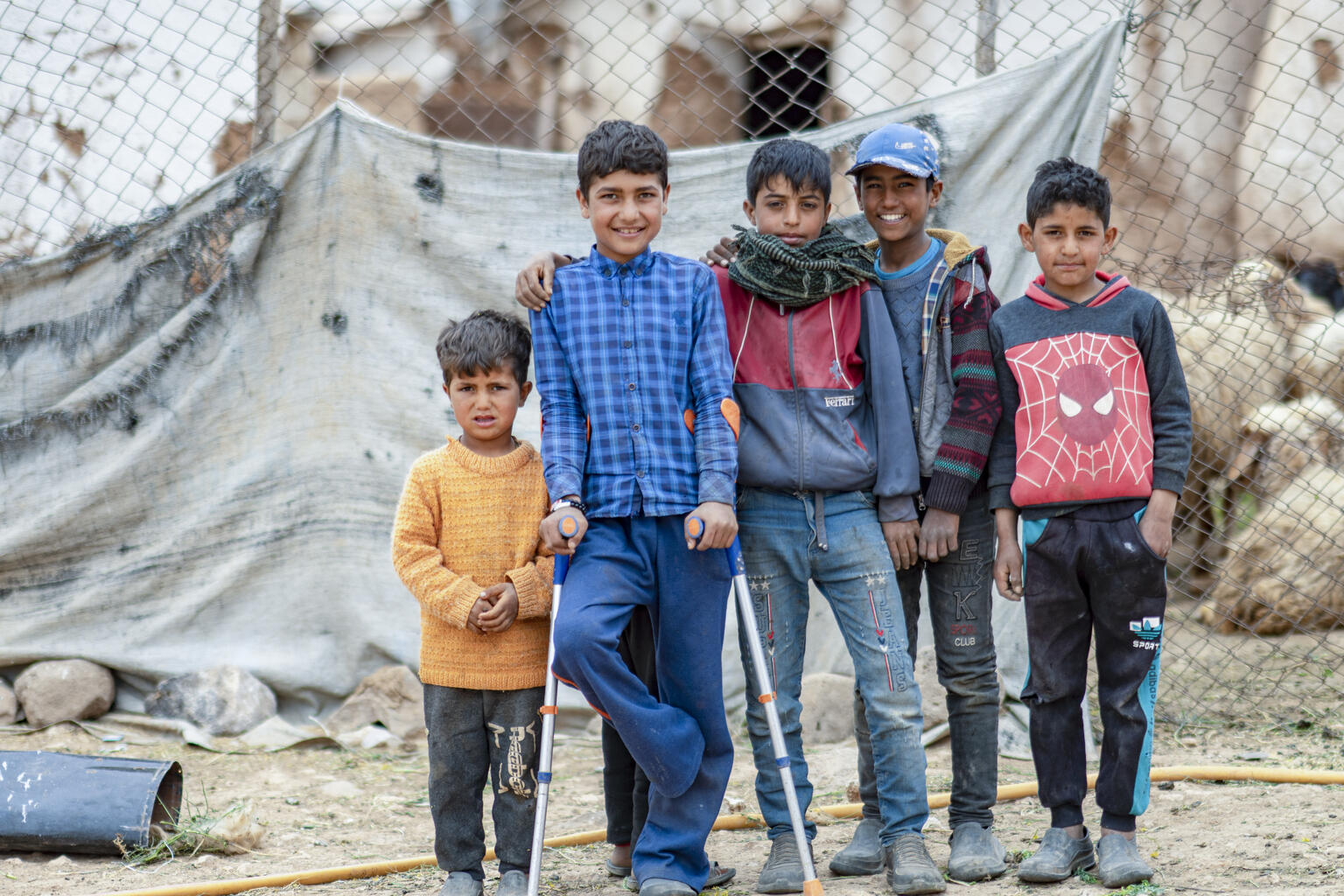 Jumaa, 12, with his friends and siblings in Abu Abdeh village, east rural Aleppo, Syria, on 19 April 2022. “I was collecting truffles with my family when I stepped on the mine,” said Jumaa, 12, recalling the time he lost his foot a year ago. Photo credit: UNICEFAdel Janji UN0646048