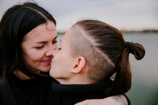 Olesia from Kyiv hugs her teenage son Matvii who lives with a disability. Olesia and her son spent the first days of the war in a basement in Kyiv.